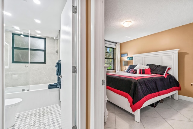 tiled bedroom featuring a textured ceiling