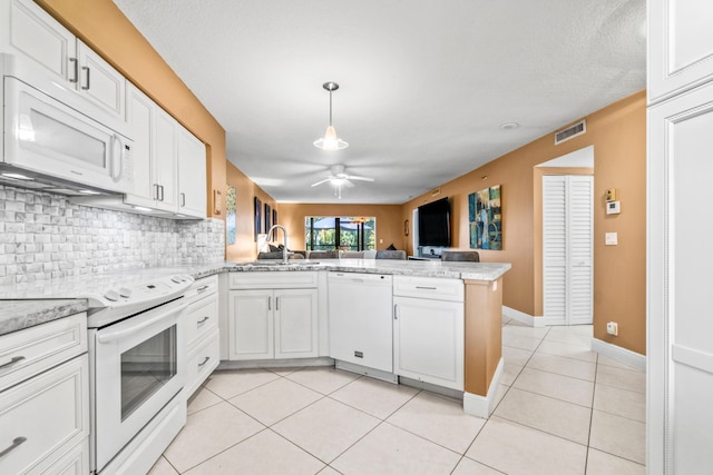 kitchen featuring kitchen peninsula, light tile patterned floors, white cabinets, and white appliances