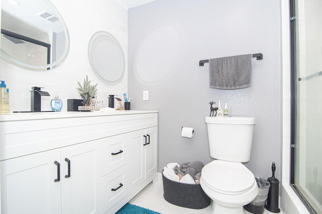 bathroom featuring a shower with door, vanity, and toilet