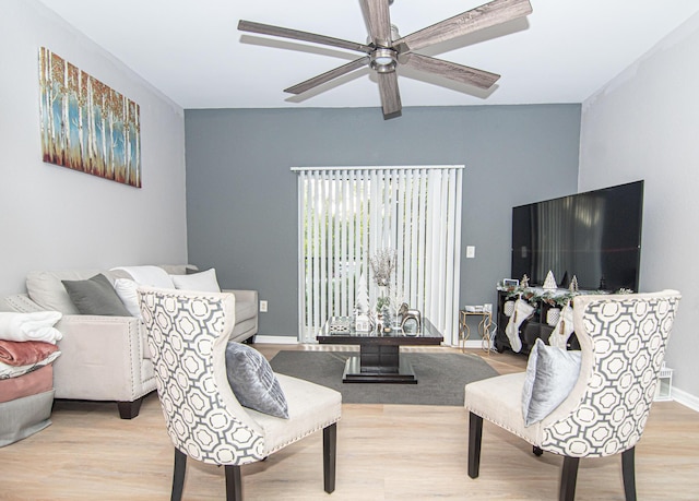 living room with ceiling fan and light wood-type flooring