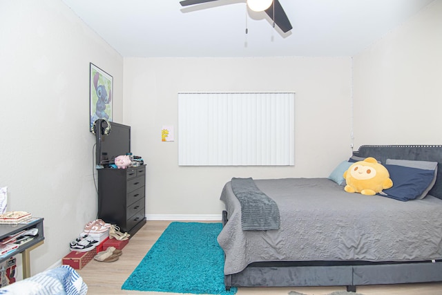 bedroom with hardwood / wood-style flooring and ceiling fan