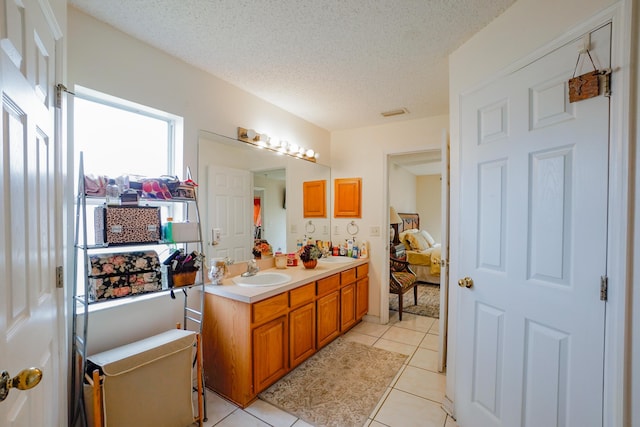 bathroom with vanity, tile patterned floors, and a textured ceiling