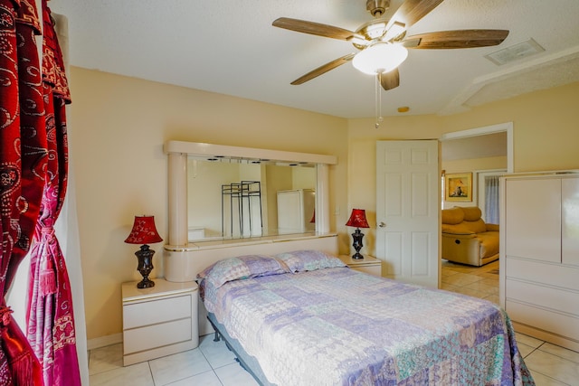 bedroom with ceiling fan and light tile patterned flooring