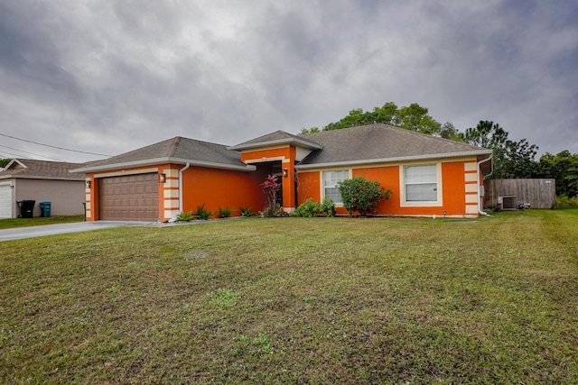 view of front of home featuring a garage, a front lawn, and central air condition unit