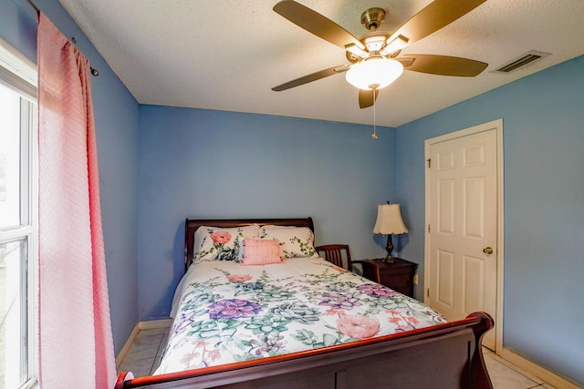 bedroom with light tile patterned floors and ceiling fan