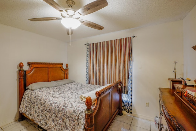 bedroom with light tile patterned flooring, ceiling fan, and a textured ceiling