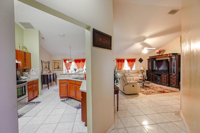 kitchen with hanging light fixtures, stainless steel electric range oven, vaulted ceiling, and light tile patterned floors