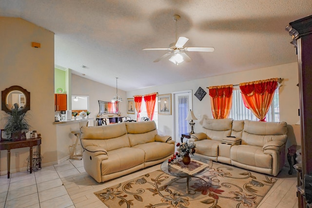 living room with ceiling fan, light tile patterned floors, vaulted ceiling, and a textured ceiling