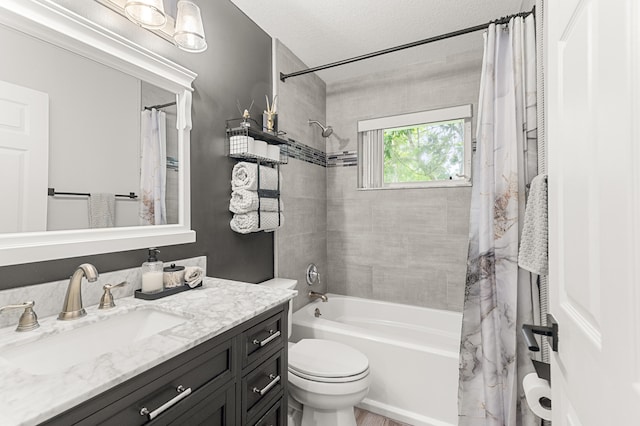 full bathroom featuring vanity, toilet, a textured ceiling, and shower / tub combo with curtain