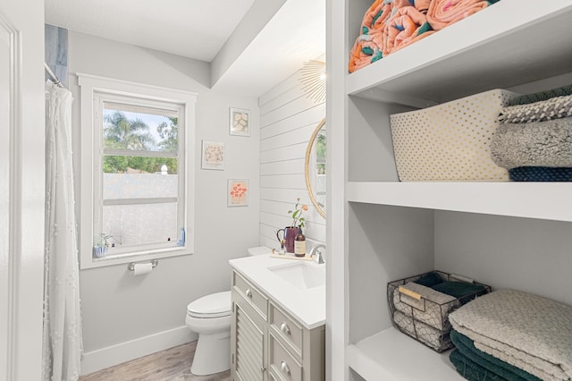 bathroom featuring hardwood / wood-style floors, vanity, and toilet