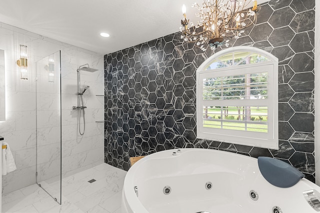 bathroom featuring separate shower and tub, a chandelier, and tile walls