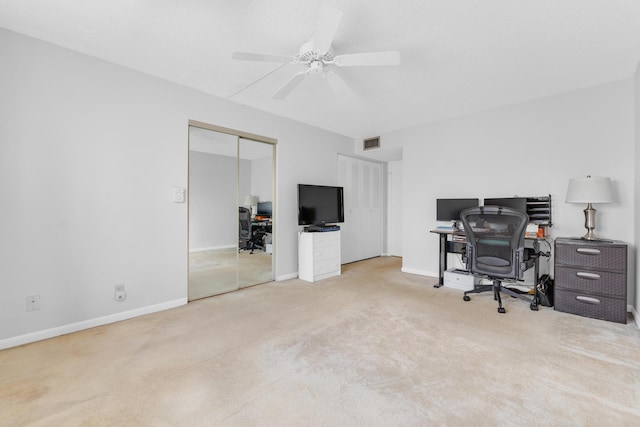 home office featuring light colored carpet and ceiling fan