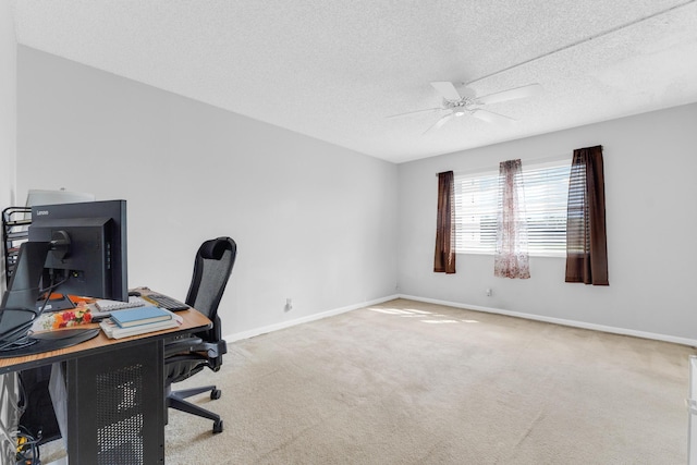 home office with carpet flooring, a textured ceiling, and ceiling fan