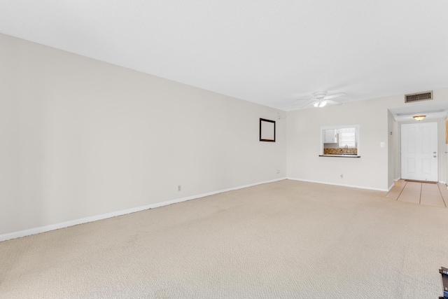 empty room featuring light colored carpet and ceiling fan