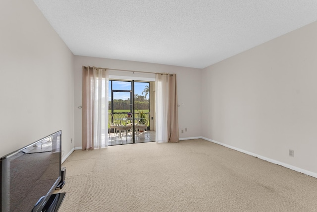 carpeted spare room featuring a textured ceiling