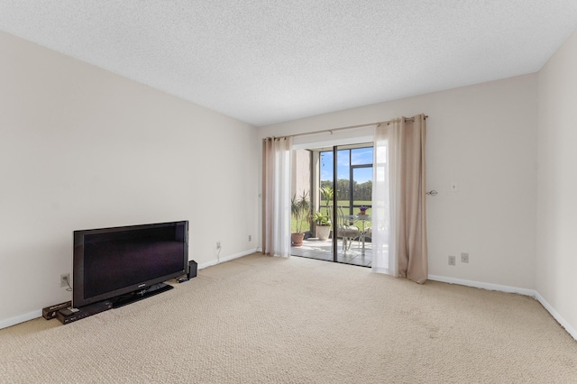 unfurnished living room with carpet floors and a textured ceiling