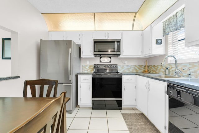 kitchen with sink, tasteful backsplash, black appliances, light tile patterned floors, and white cabinets