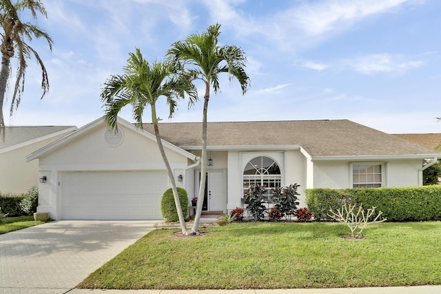 ranch-style house featuring a front yard and a garage