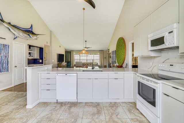 kitchen featuring white cabinetry, sink, white appliances, and kitchen peninsula