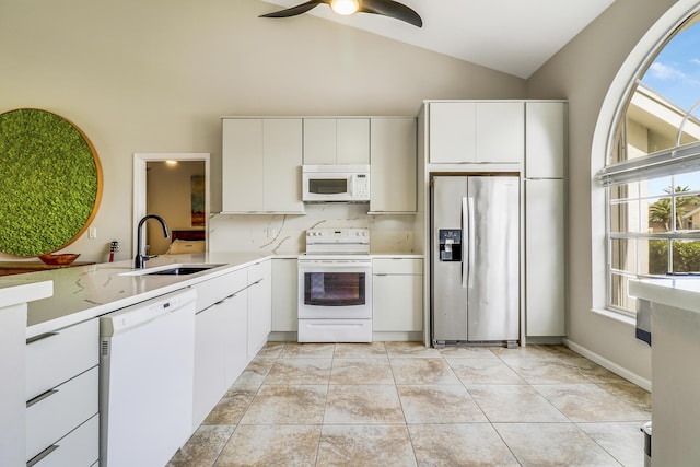 kitchen featuring tasteful backsplash, white appliances, ceiling fan, sink, and white cabinetry