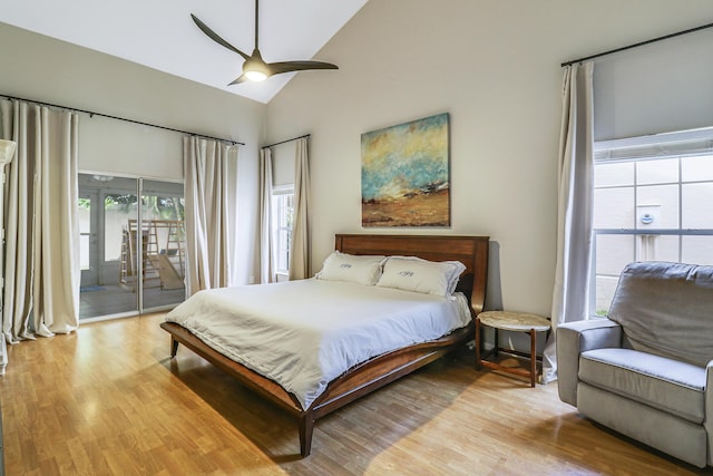 bedroom featuring ceiling fan, access to exterior, light hardwood / wood-style flooring, and vaulted ceiling