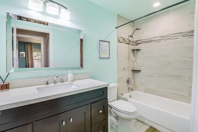 full bathroom with tile patterned flooring, vanity, toilet, and tiled shower / bath