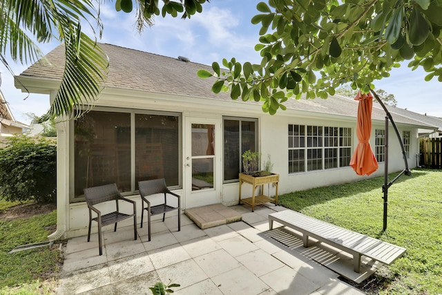 back of house with a yard and a patio area