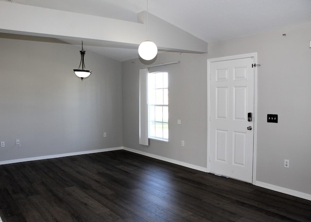 empty room featuring baseboards, vaulted ceiling, and dark wood-type flooring