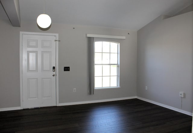 foyer featuring dark wood finished floors and baseboards