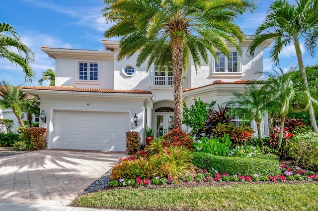 mediterranean / spanish-style house featuring a balcony and a garage