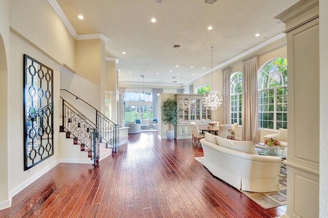 interior space with wood-type flooring, crown molding, stairway, and baseboards