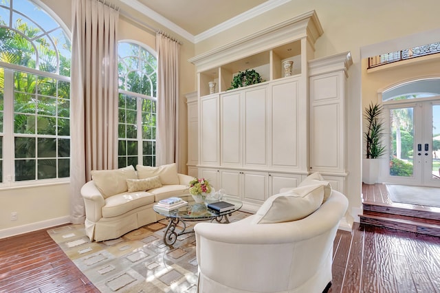 interior space with wood-type flooring, crown molding, and french doors