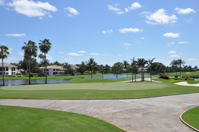 surrounding community with a lawn and a water view