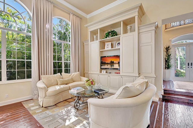 living area featuring crown molding, hardwood / wood-style floors, and french doors