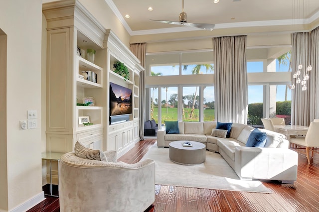 living room with ceiling fan, hardwood / wood-style floors, built in features, and ornamental molding