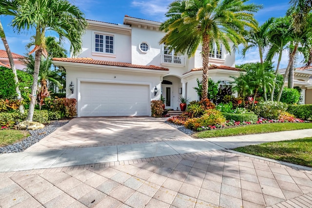 mediterranean / spanish-style home featuring a balcony and a garage