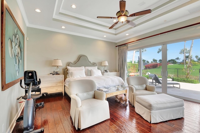 bedroom featuring hardwood / wood-style flooring, ceiling fan, access to exterior, ornamental molding, and a tray ceiling