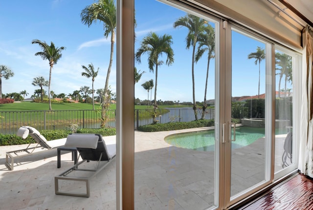 doorway to outside with plenty of natural light and a water view