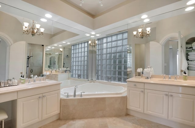 bathroom featuring tile patterned floors, a notable chandelier, vanity, and independent shower and bath