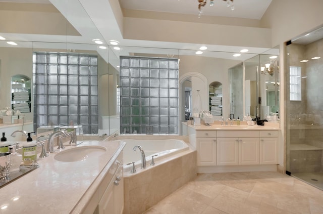 bathroom with tile patterned flooring, vanity, and independent shower and bath