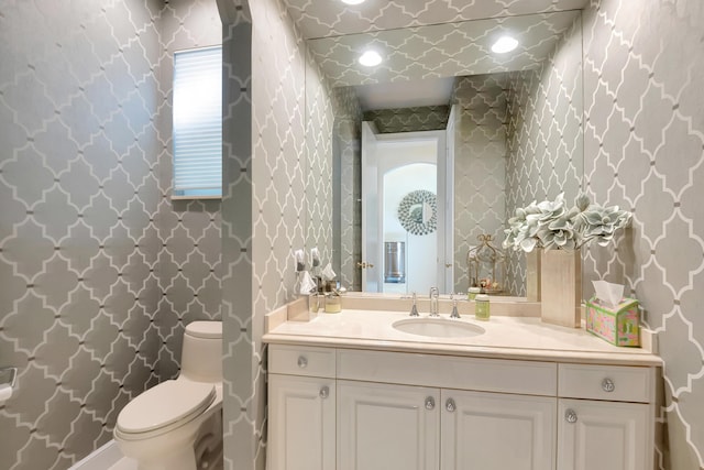 bathroom featuring vanity and toilet