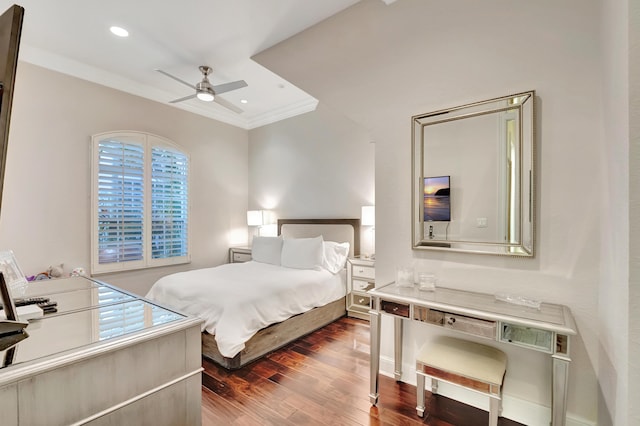 bedroom featuring dark hardwood / wood-style flooring, ceiling fan, and crown molding