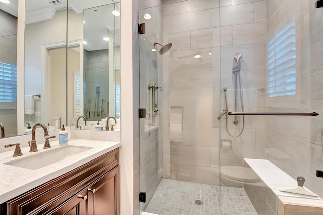 bathroom featuring crown molding, vanity, and walk in shower