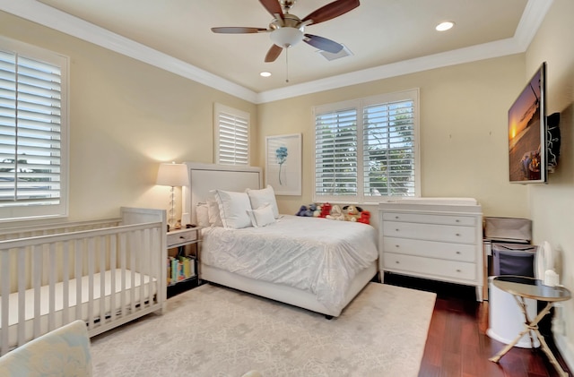 bedroom with wood-type flooring, ceiling fan, and crown molding