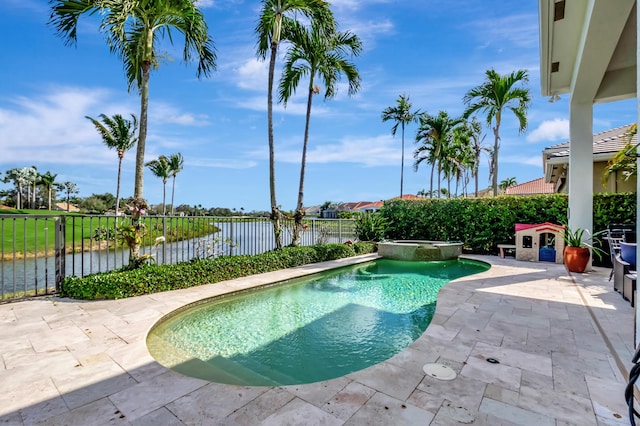 view of pool with a patio and a water view