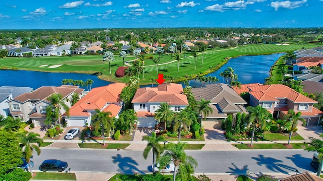 bird's eye view with a residential view, view of golf course, and a water view