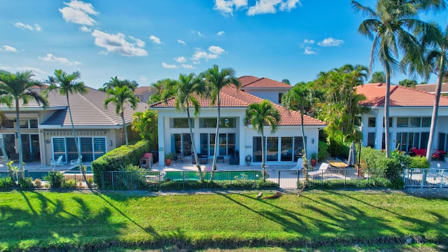 back of property with a patio and a lawn