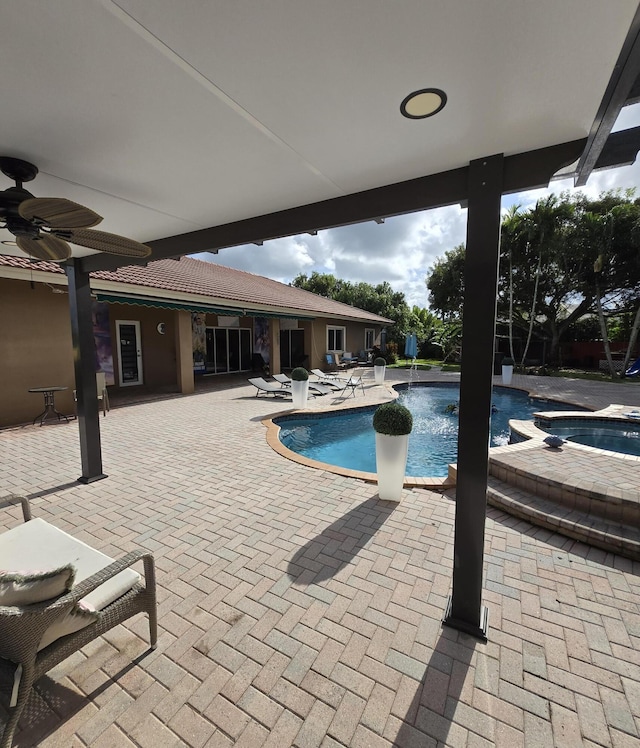 view of pool featuring an in ground hot tub and a patio area