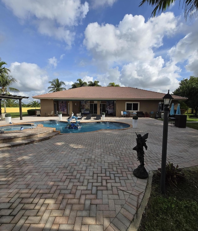 view of swimming pool featuring an in ground hot tub and a patio