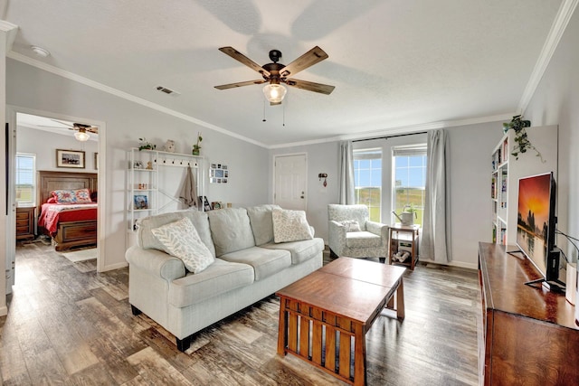 living room featuring a textured ceiling, ceiling fan, wood-type flooring, and crown molding